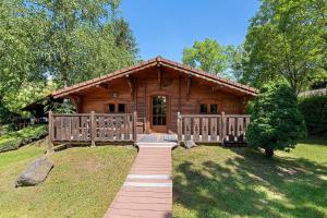 a log cabin with a walkway in front of it at Camping L'imprévu in Vaulnaveys-le-Bas