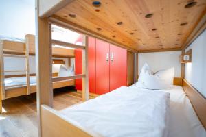 a small room with two beds and a bunk bed at Jugendherberge Ravensburg in Ravensburg