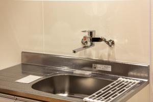 a sink in a kitchen with a faucet at HOTEL Itsuki in Onomichi +33 photos