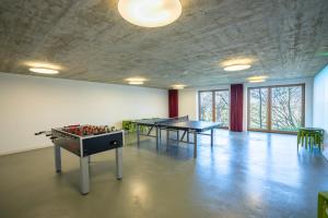 a large room with tables and chessboards in it at Jugendherberge Ravensburg in Ravensburg +16 photos