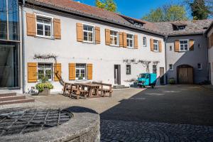 a building with a table and benches in front of it at Jugendherberge Ravensburg in Ravensburg