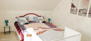 a white crib in a room with a bed at Ferienhaus Medebach in Medebach
