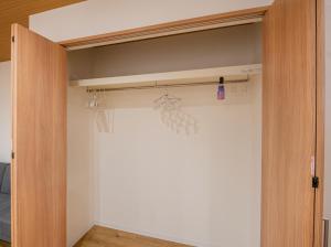 a closet with a door open with a curtain at HOTEL Itsuki in Onomichi
