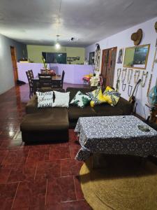 a living room with a couch and a table at Hare Maohi in Hanga Roa +7 photos