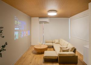 a living room with a couch and a table at HOTEL Itsuki in Onomichi