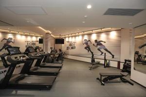 a gym with a row of treadmills and a group of people running on at סי סייד אילת - Sea Side Eilat in Eilat