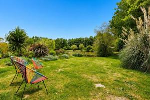 a colorful bench sitting in the grass in a garden at Gite Douceur de vivre in Saint-Avaugourd-des-Landes