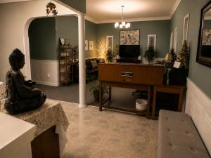 a living room with a couch and a desk with a television at NEWCASTLE COUNTRY INN in Drumheller +8 photos