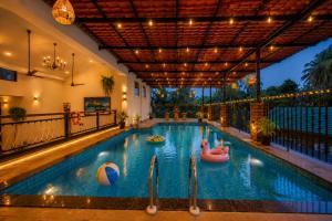 a swimming pool with inflatables in a house at Dimaru Boutique Hotel in Calangute