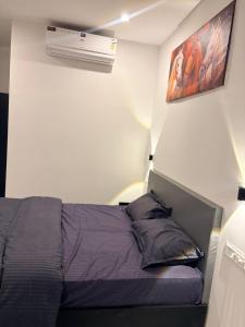 a bedroom with a bed and a air conditioner at Restara Tower in Cochin