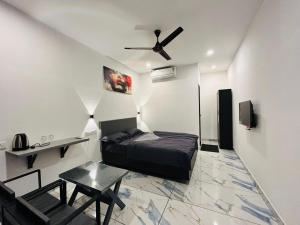 a bedroom with a bed and a ceiling fan at Restara Tower in Cochin