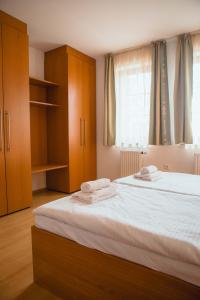 a bedroom with a bed with wooden cabinets and a window at Apartmány Nový Svět in Třeboň II