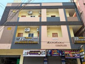 a building with speakers on the side of it at Hotel Gokulam Grand in Tenāli