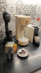 a counter top with a coffee maker and a coffee maker at Kipseli house in Athens