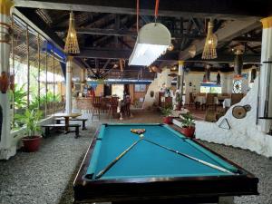 a pool table in the middle of a room at Bermuda Beach Resort in Lagob