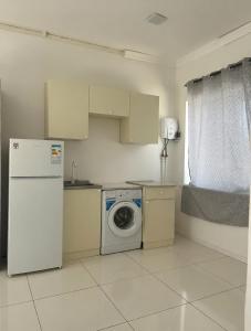 a kitchen with a refrigerator and a washing machine at Арев in Yerevan