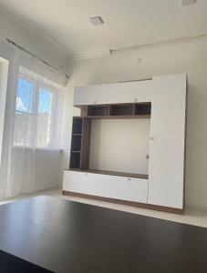 a large white cabinet in a room with a window at Арев in Yerevan