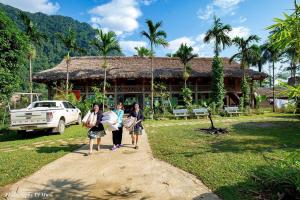 a group of people walking in front of a house at Homestay Xuân Sơn 2 in Phú Thọ