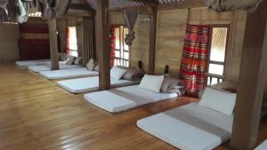 a room with white couches in a room with wooden floors at Homestay Xuân Sơn 2 in Phú Thọ +39 photos