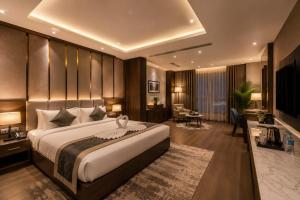 a hotel room with a large bed and a desk at Hotel Veloria Grand IGI Airport Delhi in New Delhi