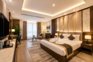 a bedroom with a large bed and a living room at Hotel Veloria Grand IGI Airport Delhi in New Delhi