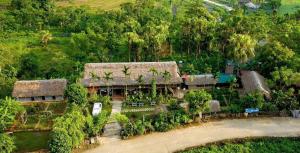 an aerial view of a house with a straw roof at Homestay Xuân Sơn 2 in Phú Thọ