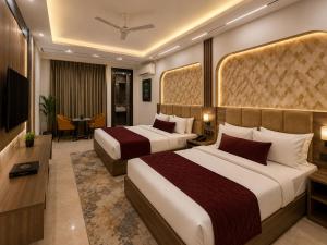 a hotel room with two beds and a television at Hotel Veloria Grand IGI Airport Delhi in New Delhi +17 photos