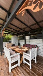 a wooden table and two chairs on a patio at Casa ISEHEIA in Sibiel +41 photos