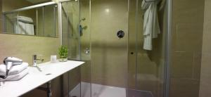 a bathroom with a shower with a glass door at H2 Fuenlabrada in Fuenlabrada +14 photos
