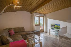 a living room with a couch and a table at Ferienwohnungen Dagn in Kössen