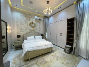 a bedroom with a large bed and a mirror at Luxury 5 BR Villa with Pool,Cinema Lekki in Lekki +25 photos