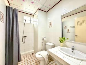 a bathroom with a toilet and a sink at J Mansion in Ao Nang Beach