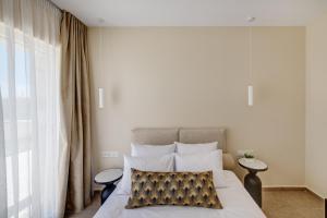 a bedroom with a bed with a pillow on it at La VILLA DELLE TORRI in Ermoupoli +71 photos