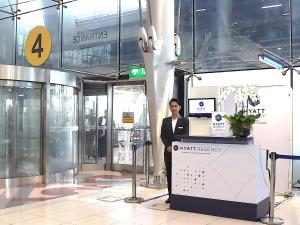 a man standing behind a podium in a building at Hyatt Regency Bangkok Suvarnabhumi Airport in Lat Krabang