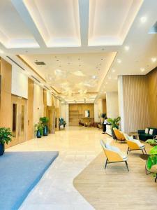 a large lobby with yellow chairs and a large room at Angela House Halong in Ha Long +57 photos
