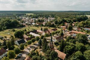 an aerial view of a small town with a church at Fliederhof Stücken Apartments bei Potsdam in Michendorf