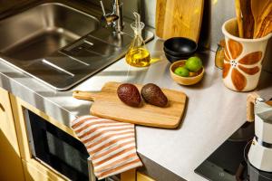 a kitchen counter with a cutting board and fruits on it at ARK Shoreditch in London +25 photos