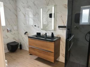 a bathroom with a black sink and a mirror at Za Wysokim Murem in Czarne