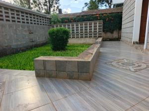 a stone bench sitting in the middle of a yard at Pazuri Ark Gardens in Thika