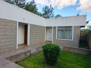 a house with a grassy yard in front of it at Pazuri Ark Gardens in Thika