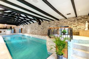 a swimming pool in a building with a brick wall at L56 - Seaglass in Truro
