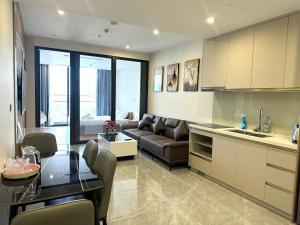 a kitchen and living room with a couch and a table at Angela House Halong in Ha Long