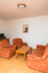 a living room with two leather couches and a coffee table at Apartmány Nový Svět in Třeboň II
