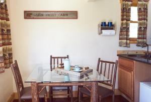 a kitchen with a table, chairs, and a table cloth at St. Mary Village in Saint Mary