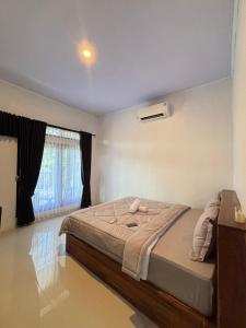 a bedroom with a bed and a window at FaqinHomestay in Pulau Sarang