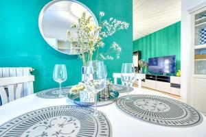a dining room with a table with glasses and a mirror at Private Parking & Garden -Luxury B&B-700mt Tower in Pisa