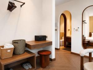 a room with a bathroom with a bed and a sink at Vistalago Hotel Khem Beach Phu Quoc in Phú Quốc