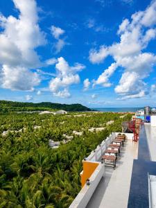 a balcony of a resort with a view of the ocean at Vistalago Hotel Khem Beach Phu Quoc in Phú Quốc