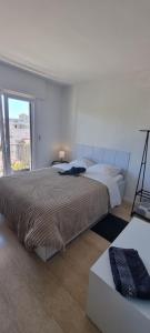 a white bedroom with a large bed and a window at Chambres d'hôtes - Bed & Breakfast - chez Denis-Jo in Toulon