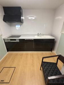 a kitchen with a sink and a counter at Bluebase 波音 in Goto